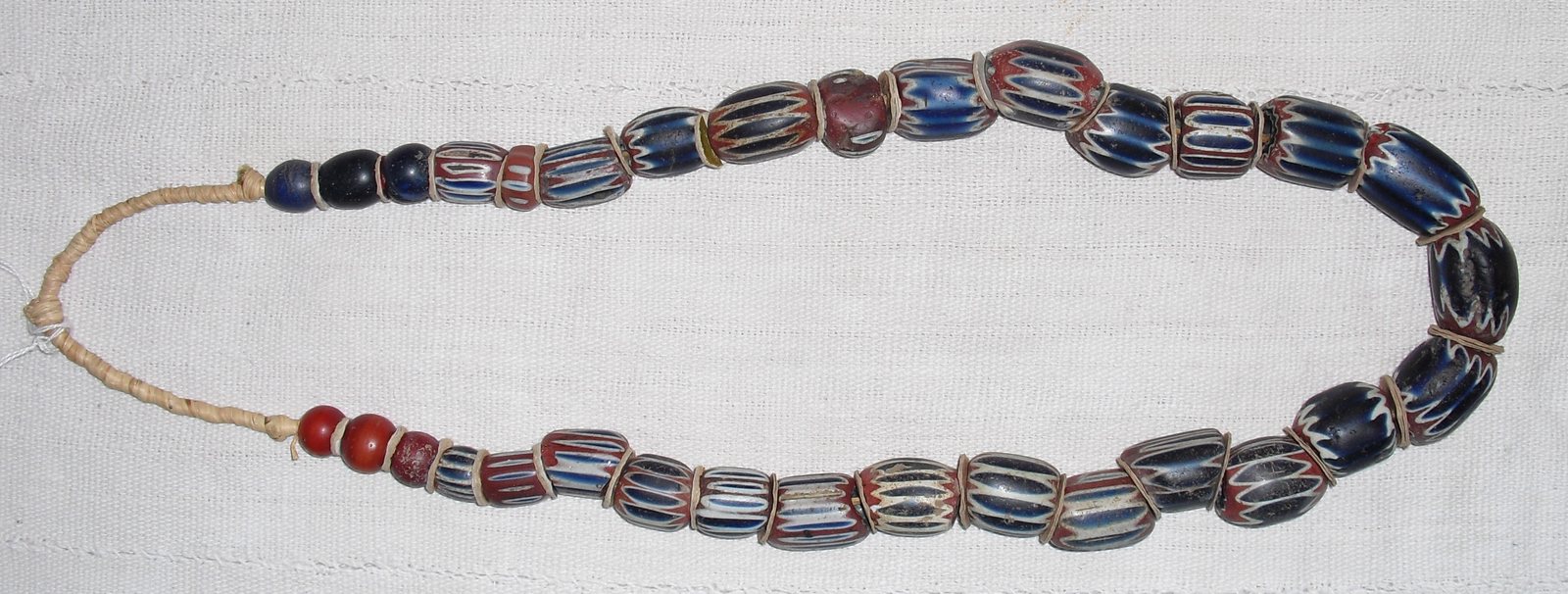 A row of striped chevron glass trade beads.