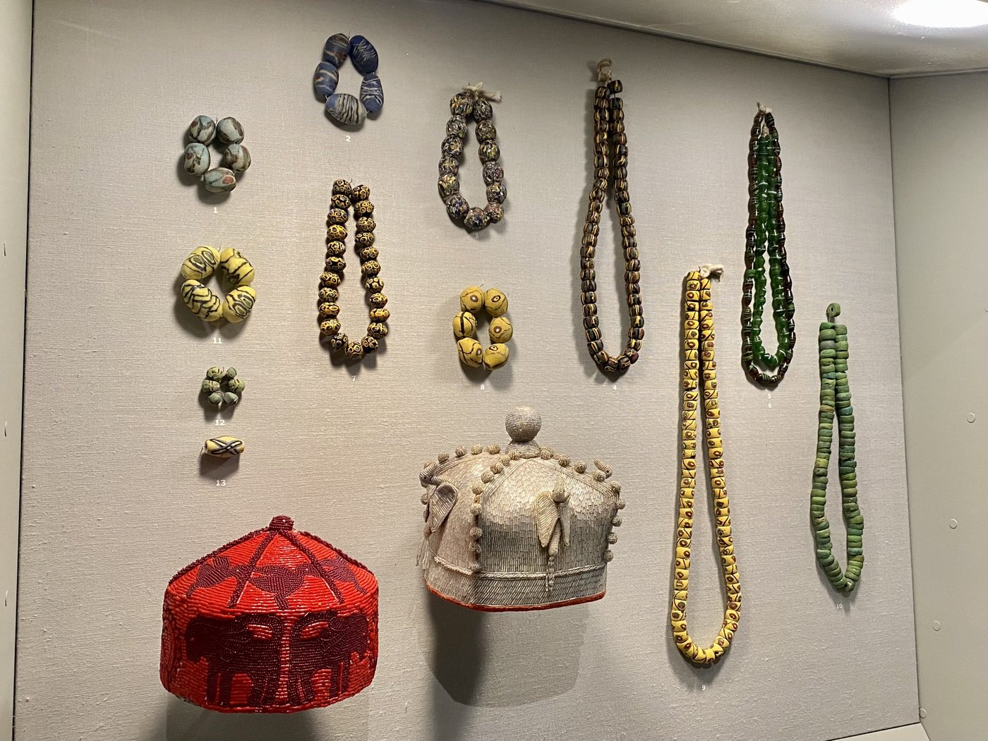 A museum case of coloured glass beads.