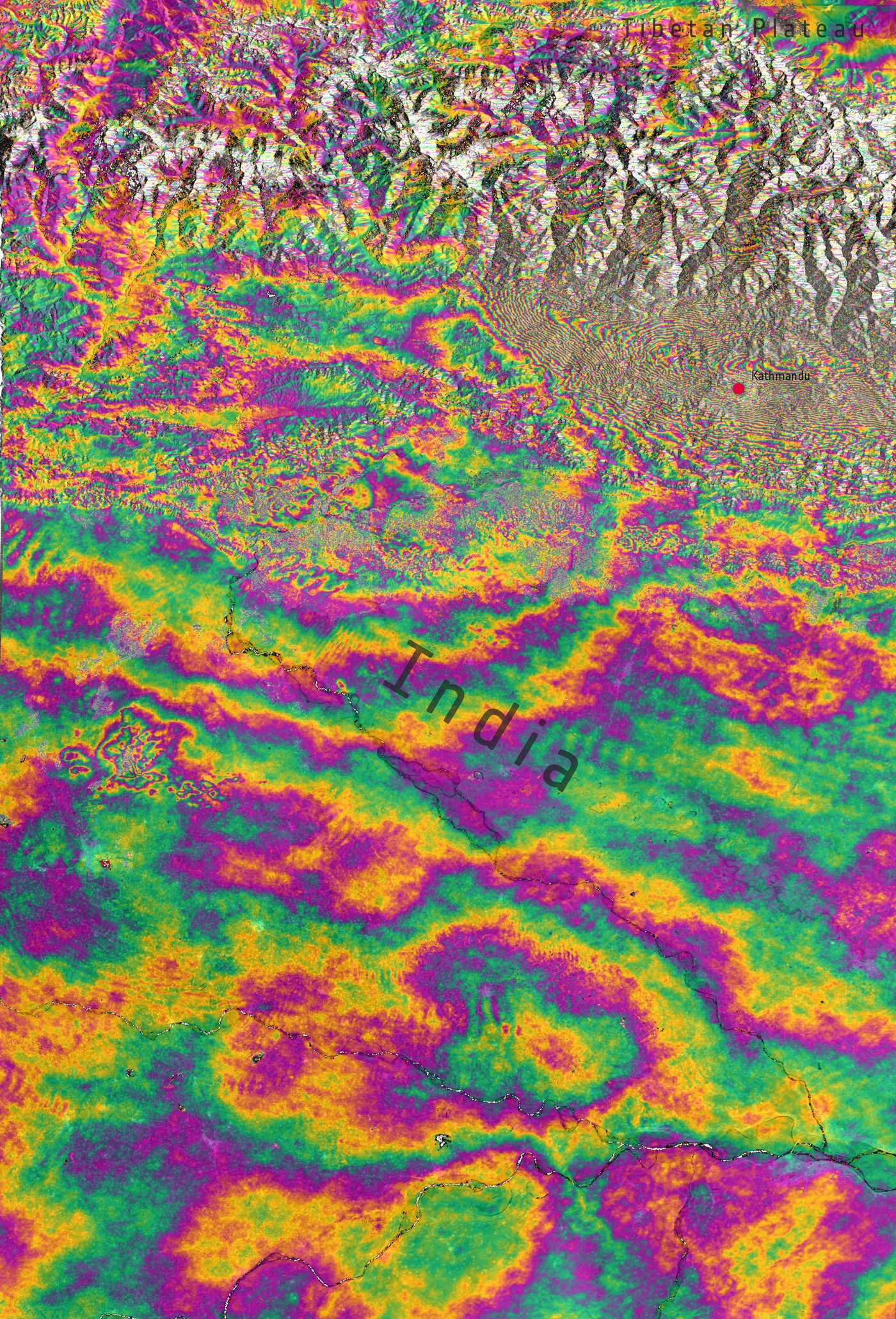 A satellite radar interferogram over Nepal: rainbow-coloured bands curving across the map where the ground moved in the 2015 earthquake