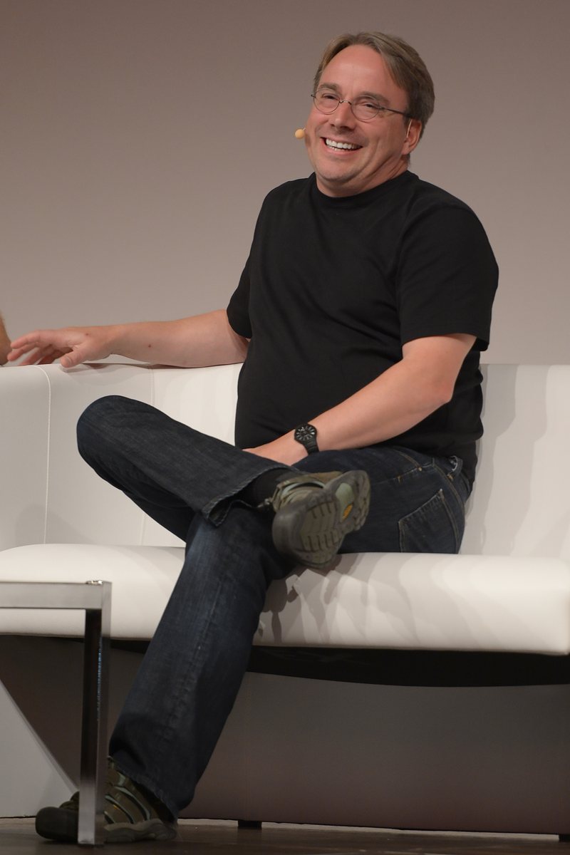 Linus Torvalds sitting on a couch on stage at LinuxCon Europe