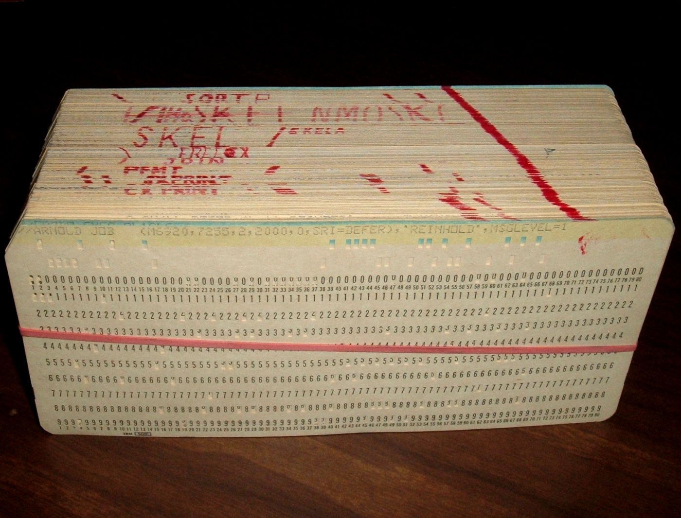 A deck of punched cards held together with a rubber band