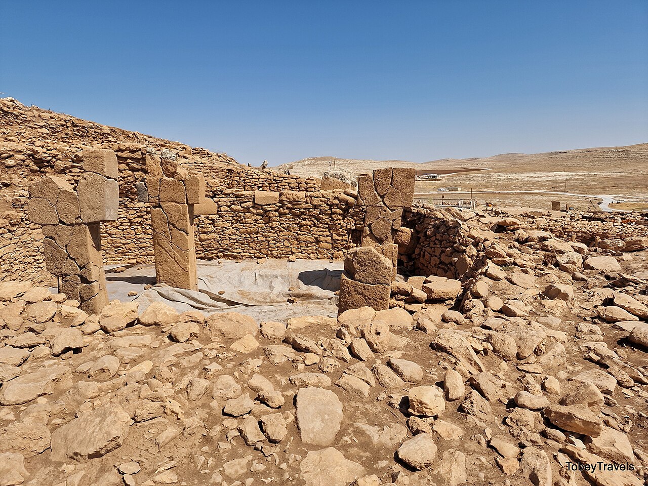 An enclosure of T-shaped limestone pillars set into stone walling at Karahan Tepe in southeastern Turkey.