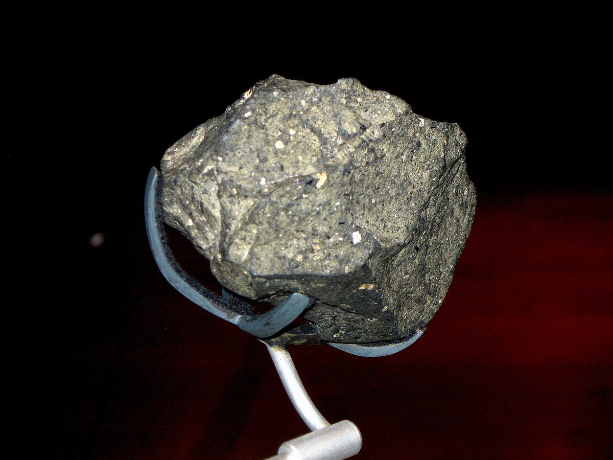 An Oldowan chopper from Olduvai Gorge on a museum mount.